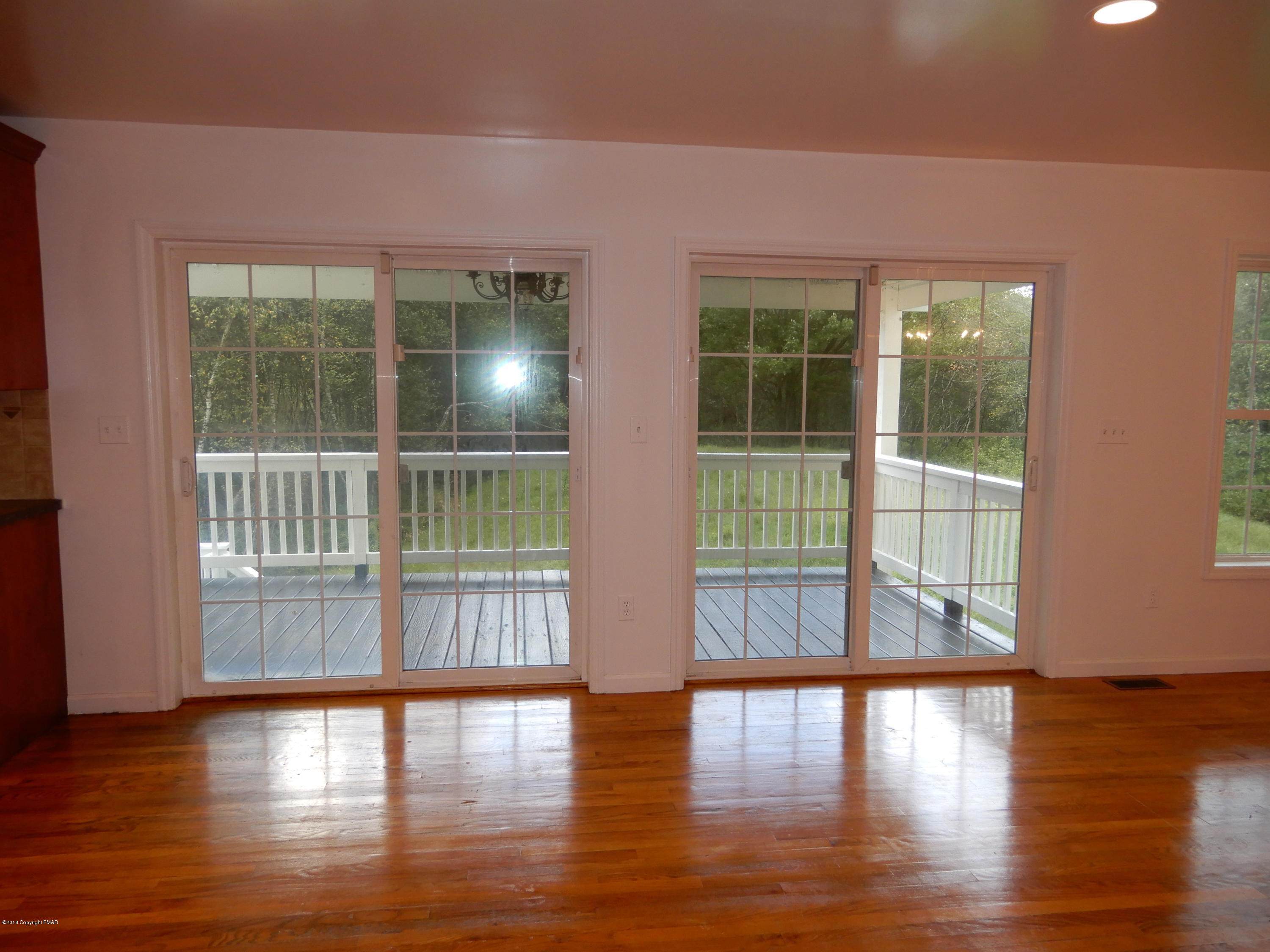 251 Sage Road Long Pond, PA 18334 - Photo 14 of 37 Kitchen Dining w/ Doors to Covered Porch