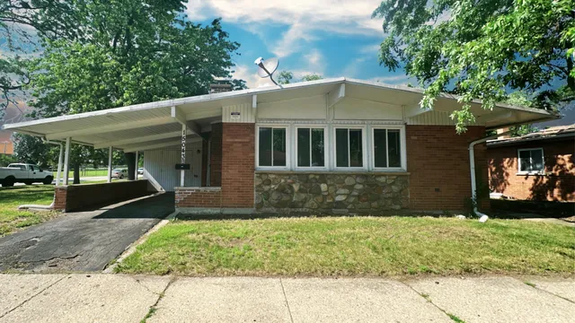 a view of a brick house with a yard
