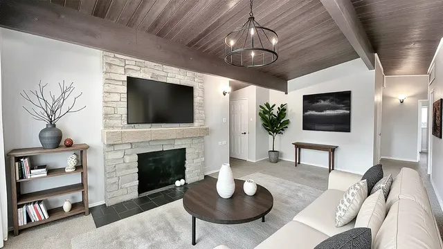 a living room with furniture a fireplace and a flat screen tv
