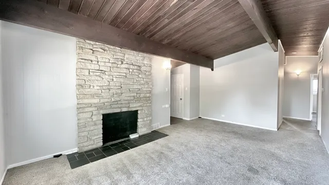 a view of empty room with fireplace