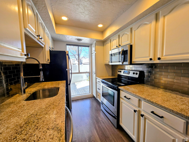 5265 South Rome Beauty Park Murray, UT 84123 - Photo 21 of 35 Kitchen featuring stainless steel appliances, recessed lighting, a raised ceiling, backsplash, and dark wood-style floors
