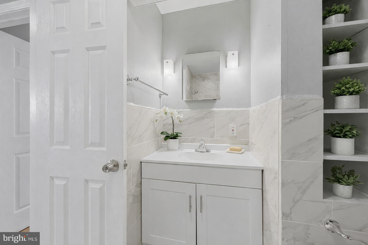 911 Homberg Avenue Baltimore, MD 21221 - Photo 12 of 28 a bathroom with a sink and a mirror