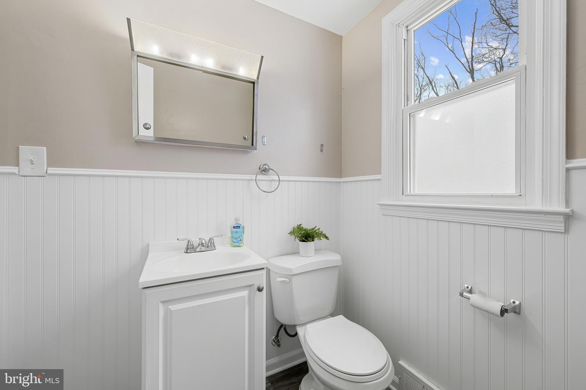 911 Homberg Avenue Baltimore, MD 21221 - Photo 19 of 28 a bathroom with a sink toilet and a mirror