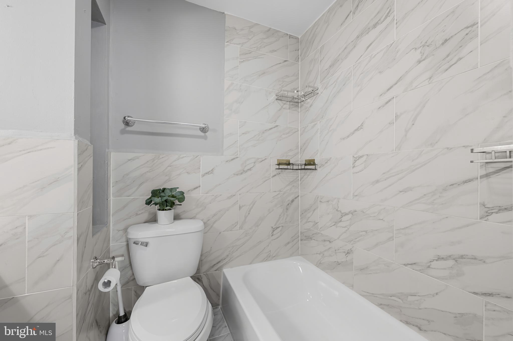 911 Homberg Avenue Baltimore, MD 21221 - Photo 20 of 28 a white toilet sitting next to a bath tub