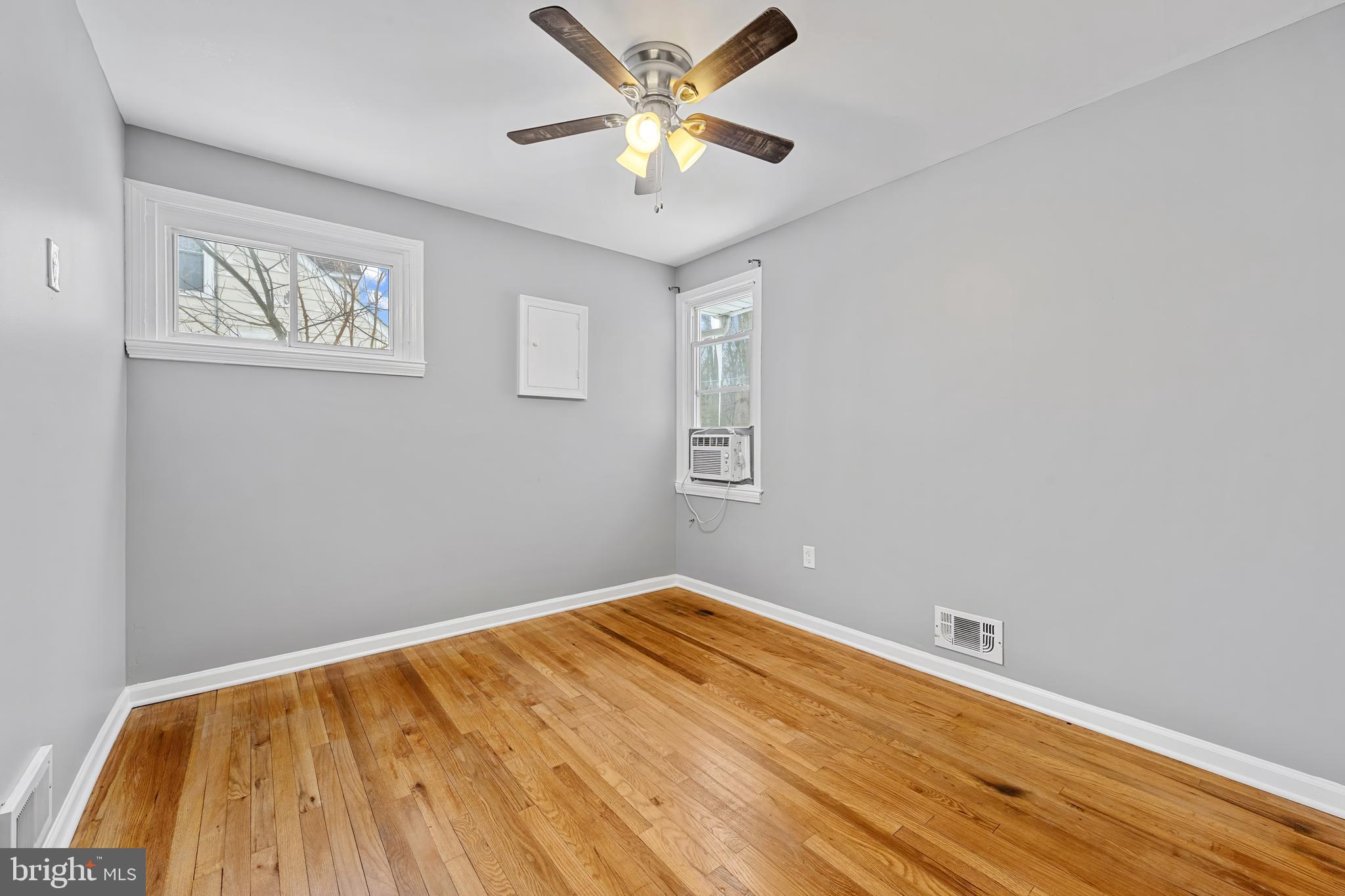 911 Homberg Avenue Baltimore, MD 21221 - Photo 21 of 28 a view of a big room with wooden floor and a chandelier fan