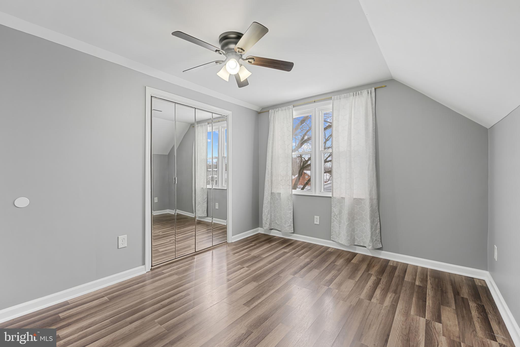 911 Homberg Avenue Baltimore, MD 21221 - Photo 23 of 28 wooden floor in an empty room with a window