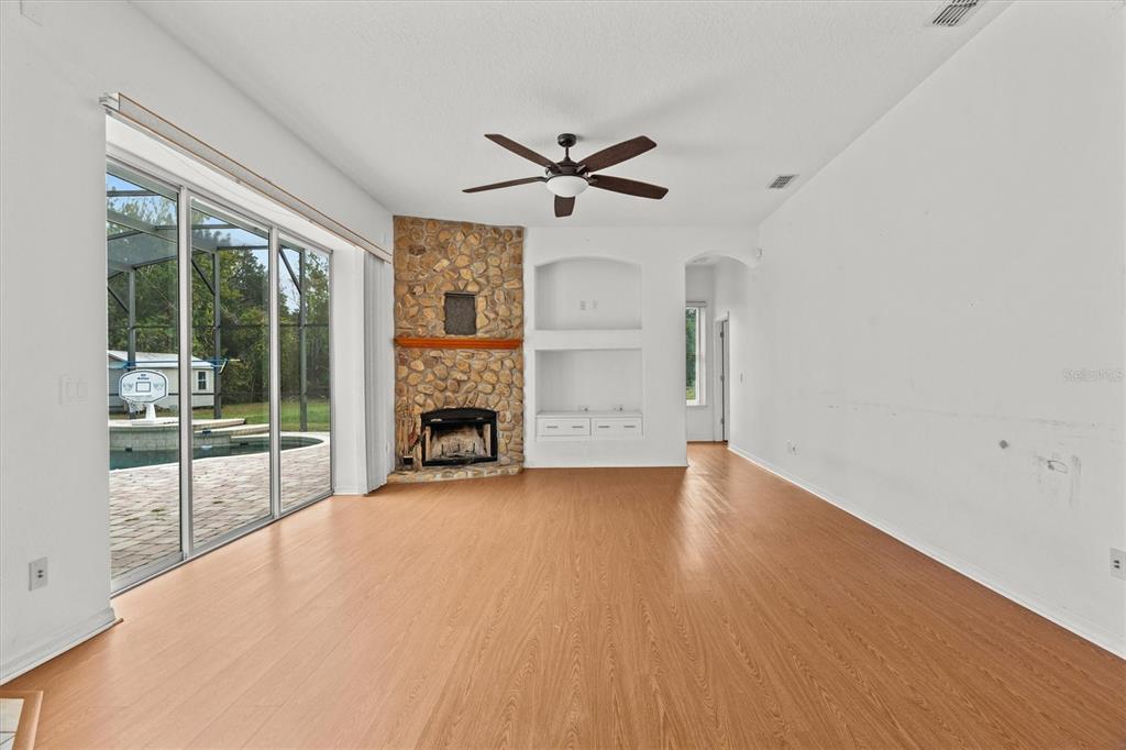 20744 Sheldon Street Orlando, FL 32833 - Photo 15 of 50 a view of an empty room with a fireplace and a window