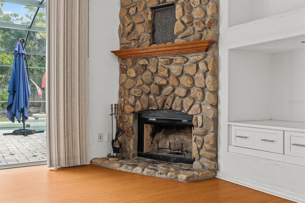 20744 Sheldon Street Orlando, FL 32833 - Photo 16 of 50 a view of an empty room with wooden floor and a fireplace
