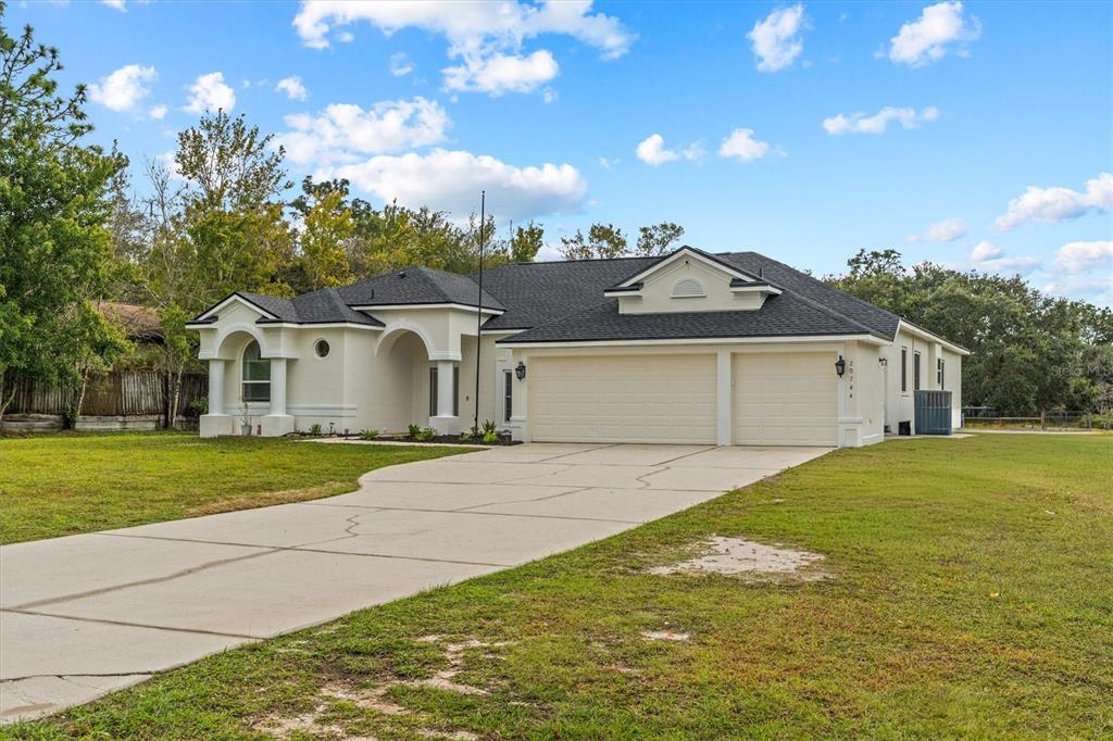 20744 Sheldon Street Orlando, FL 32833 - Photo 4 of 50 a front view of a house with a yard and garage