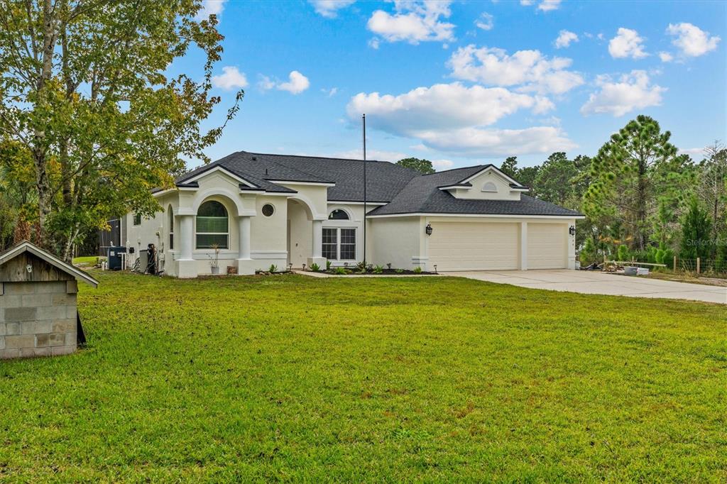 20744 Sheldon Street Orlando, FL 32833 - Photo 48 of 50 a view of a white house with a big yard and potted plants