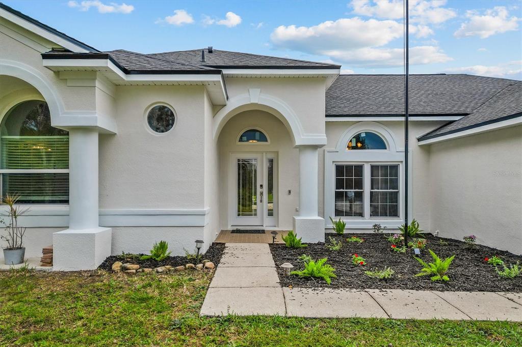 20744 Sheldon Street Orlando, FL 32833 - Photo 5 of 50 a front view of a house with garden