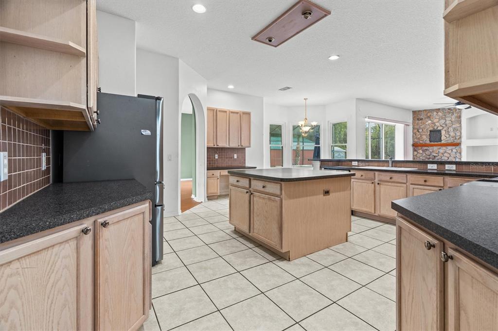20744 Sheldon Street Orlando, FL 32833 - Photo 10 of 50 a kitchen with stainless steel appliances granite countertop a stove a sink and a refrigerator