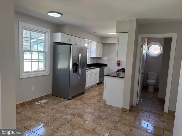 a kitchen with a refrigerator and a sink