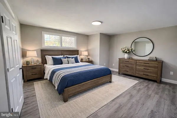 a bedroom with a bed a closet and windows