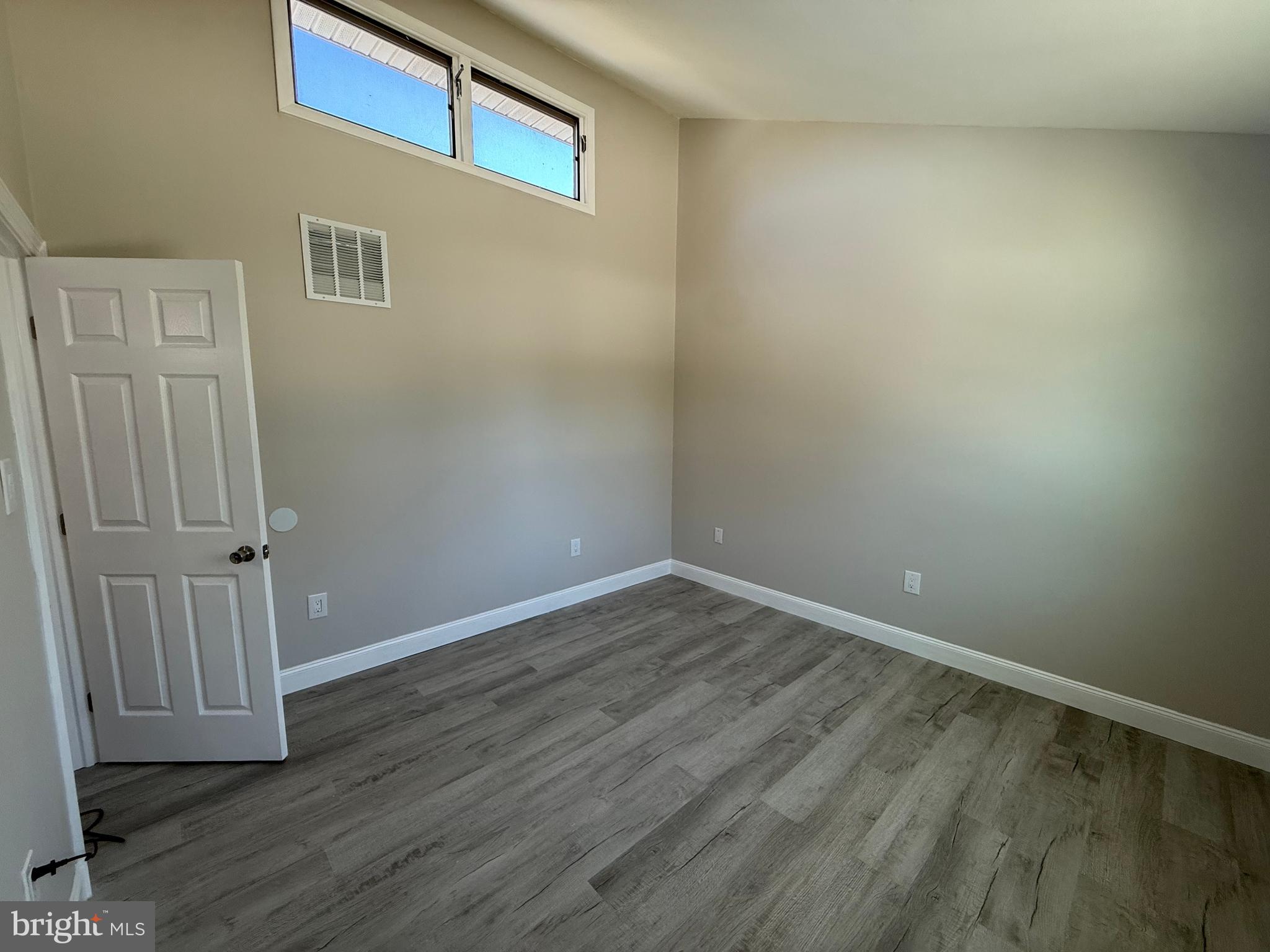 82 Dare Avenue Bridgeton, NJ 08302 - Photo 28 of 39 a view of an empty room with wooden floor and entryway