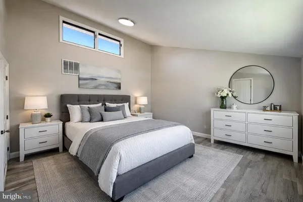 a bedroom with a bed and a dresser