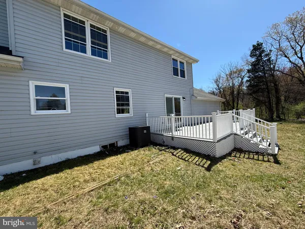 a view of a house with a wooden fence