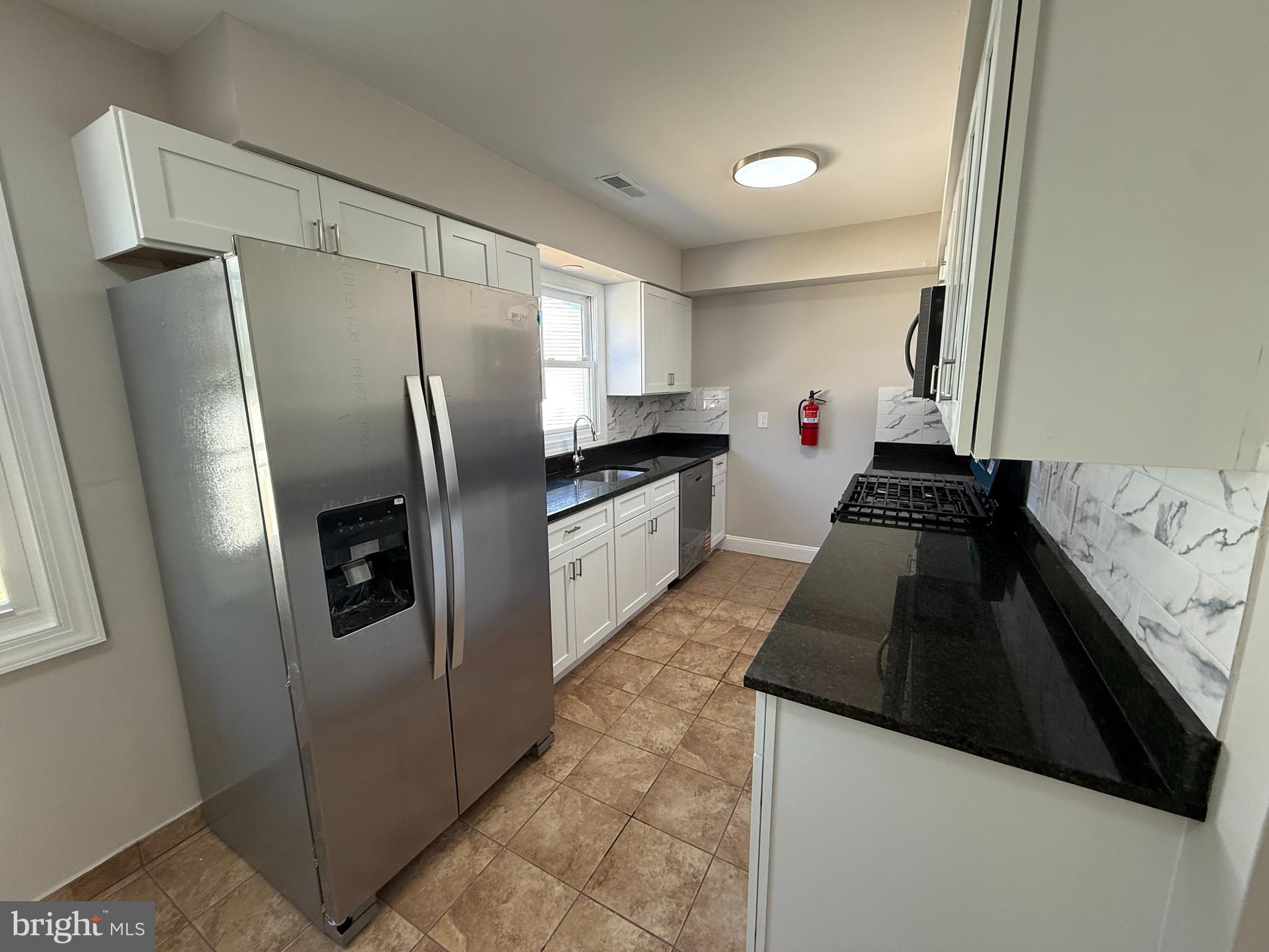 82 Dare Avenue Bridgeton, NJ 08302 - Photo 5 of 39 a kitchen with granite countertop a refrigerator and a sink