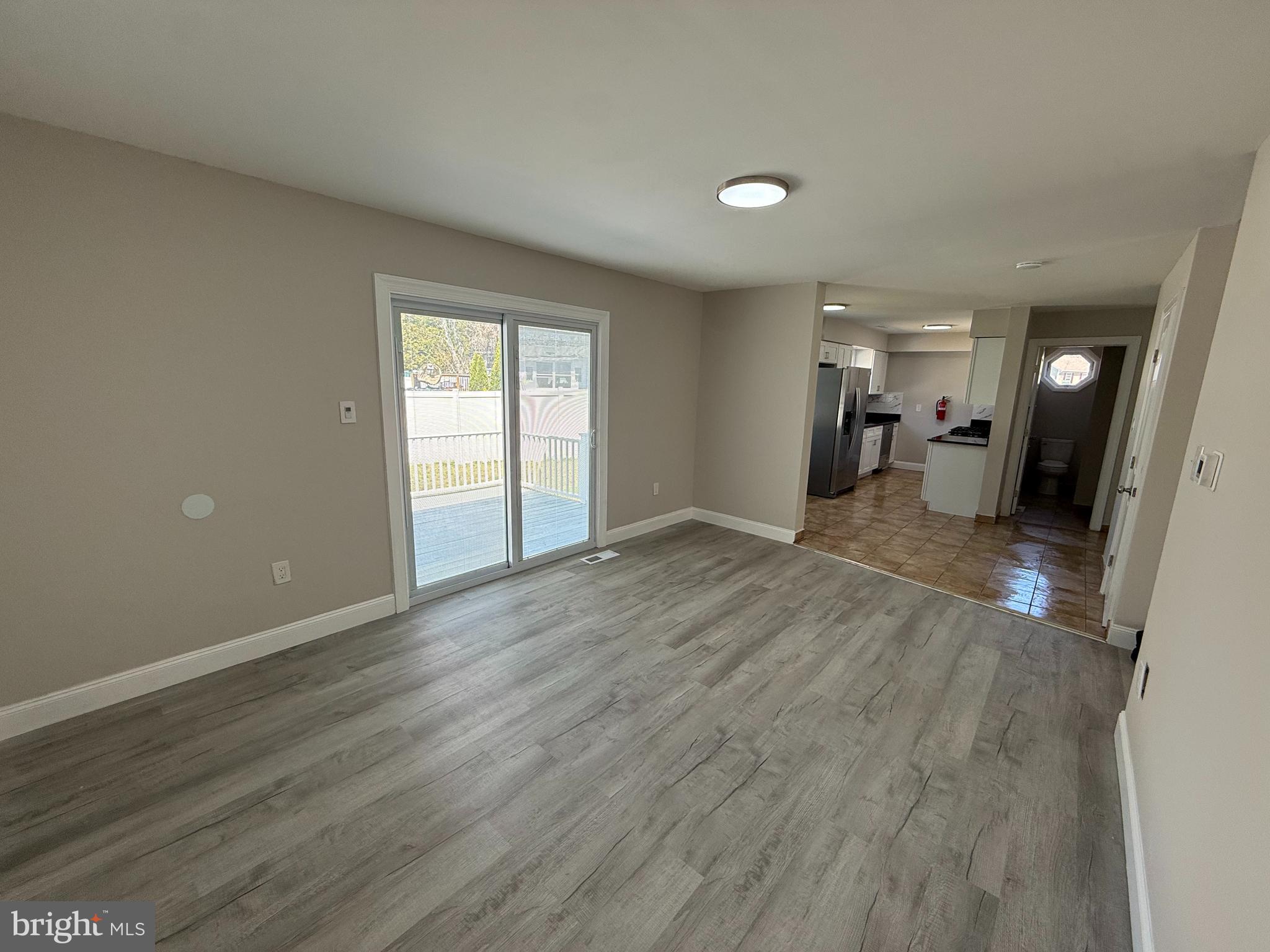 82 Dare Avenue Bridgeton, NJ 08302 - Photo 10 of 39 an empty room with wooden floor and windows