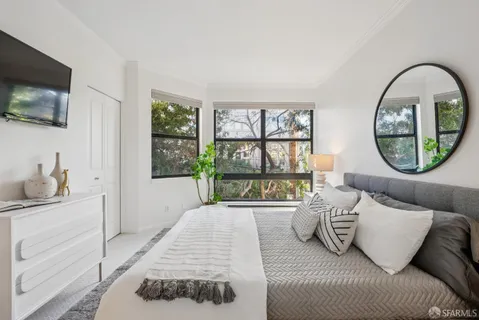 a bedroom with a bed and a flat screen television