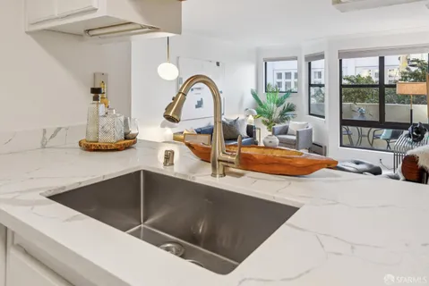 a kitchen with a refrigerator and a sink