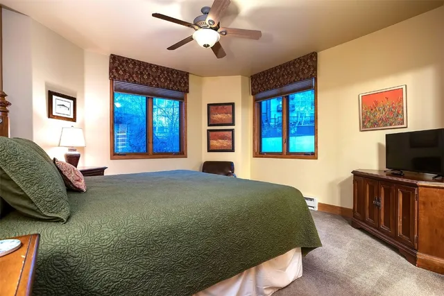 a bedroom with a bed and a flat screen television