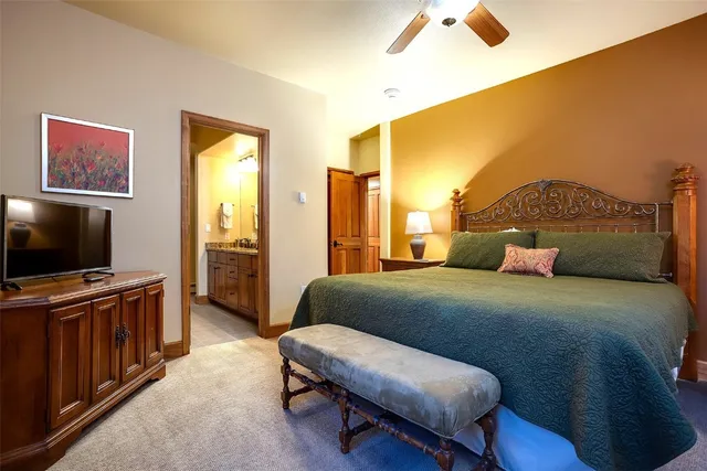 a bedroom with a bed and flat screen tv