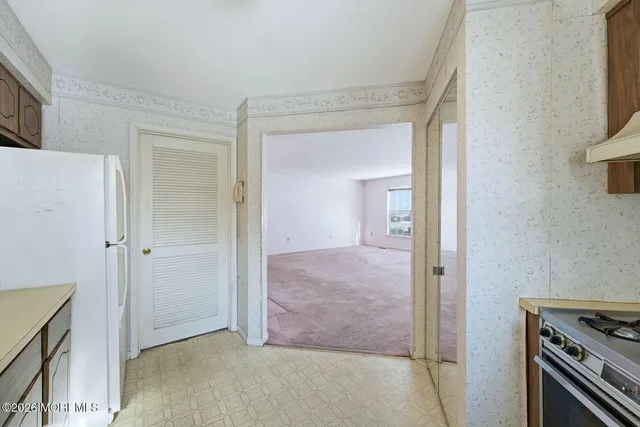 a view of a kitchen from the hallway