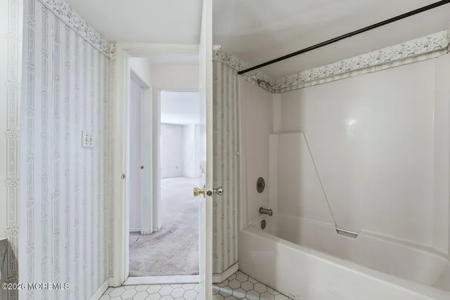 a bathroom with a shower and a bath tub