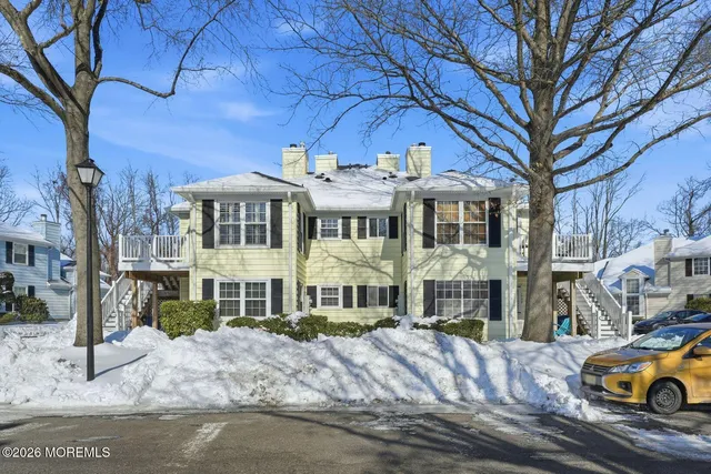 a front view of a residential apartment building with a yard
