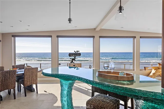 a living room with furniture a rug and a floor to ceiling window