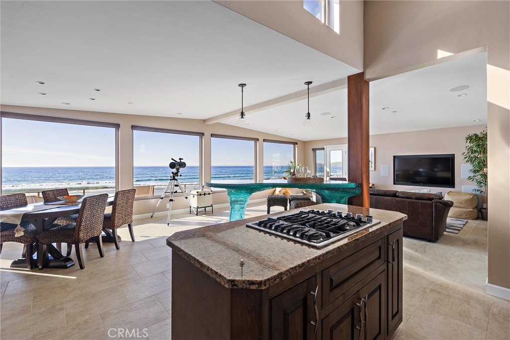 3352 Studio Drive Cayucos, CA 93430 - Photo 14 of 55 a kitchen with a stove a kitchen island a table and chairs in it