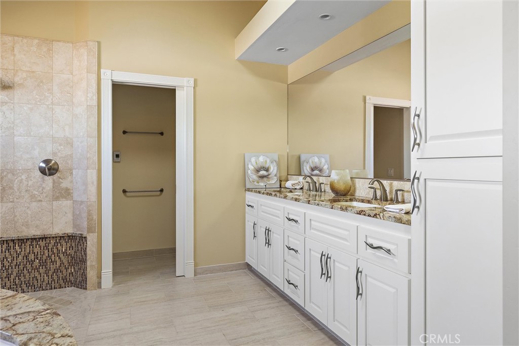 3352 Studio Drive Cayucos, CA 93430 - Photo 23 of 55 a bathroom with a granite countertop sink and a mirror