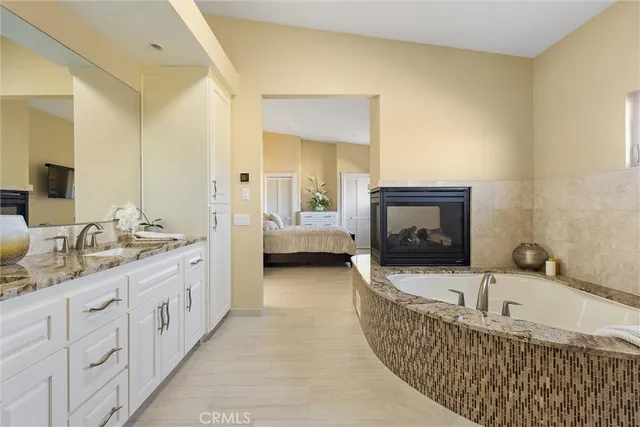 a view of a livingroom with furniture fireplace and a window