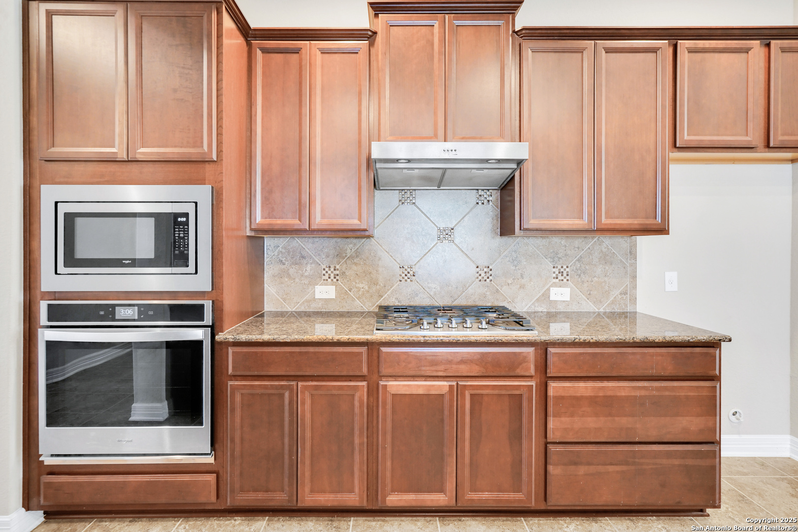 11923 Hollering Pass Schertz, TX 78154 - Photo 14 of 43 a kitchen with granite countertop cabinets stainless steel appliances and a counter space