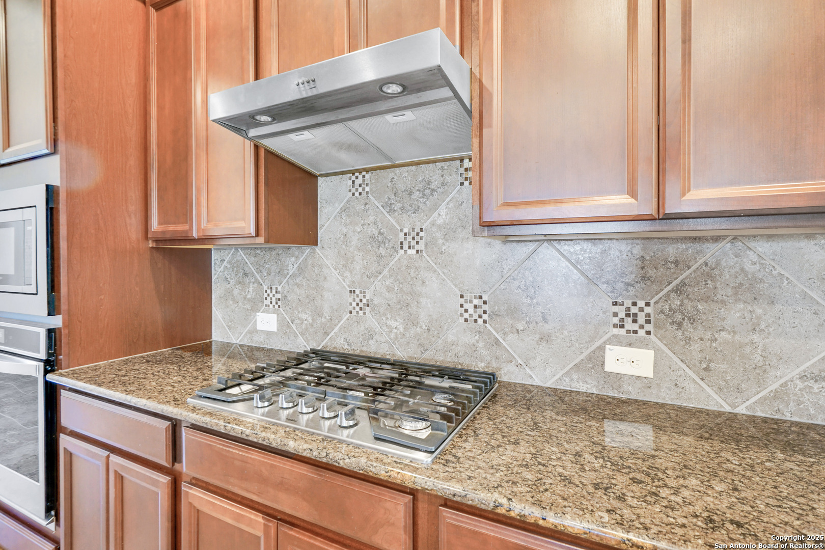 11923 Hollering Pass Schertz, TX 78154 - Photo 15 of 43 a kitchen with a stove and a cabinet
