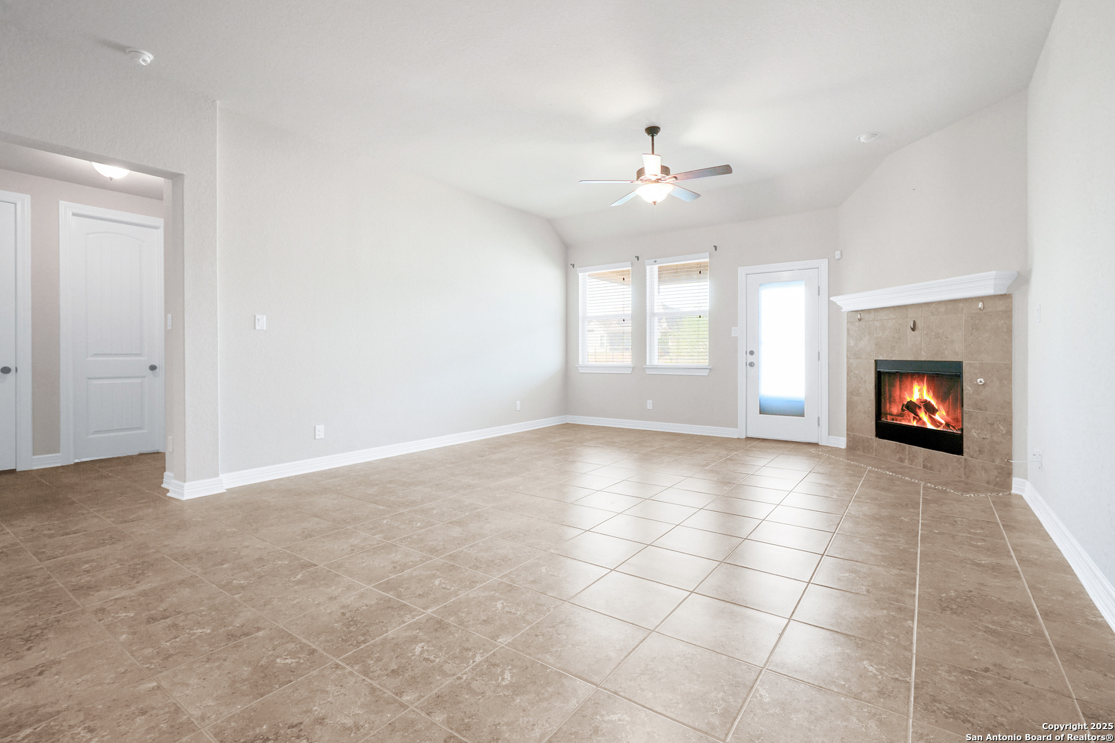 11923 Hollering Pass Schertz, TX 78154 - Photo 18 of 43 an empty room with windows and fireplace