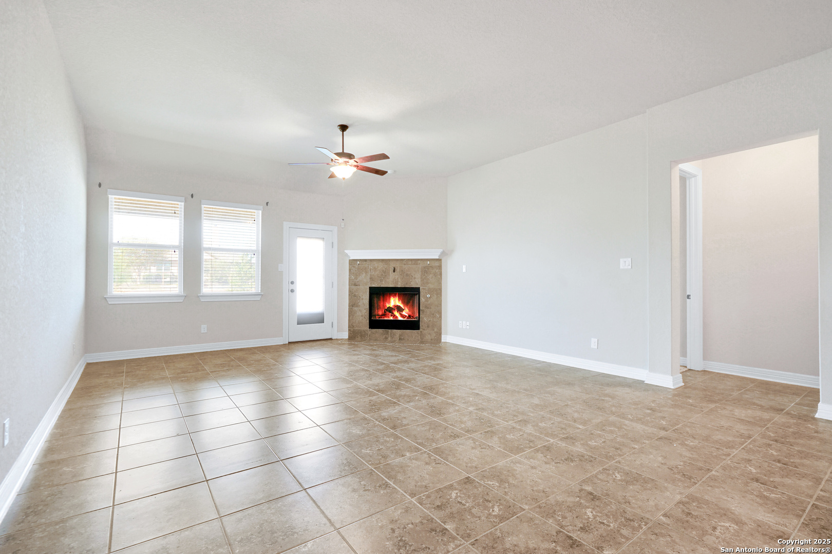 11923 Hollering Pass Schertz, TX 78154 - Photo 19 of 43 an empty room with windows and fireplace