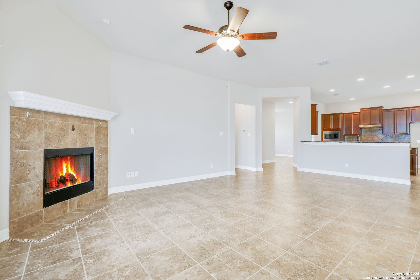 11923 Hollering Pass Schertz, TX 78154 - Photo 21 of 43 a view of an empty room with a fireplace