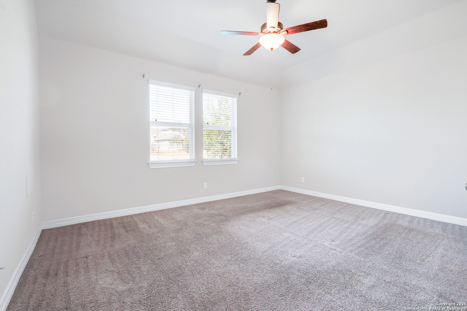 11923 Hollering Pass Schertz, TX 78154 - Photo 22 of 43 an empty room with windows and fan