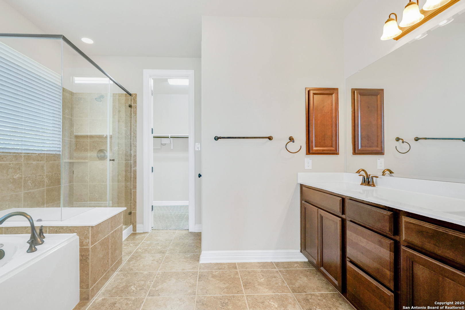11923 Hollering Pass Schertz, TX 78154 - Photo 24 of 43 a bathroom with a tub sink and mirror