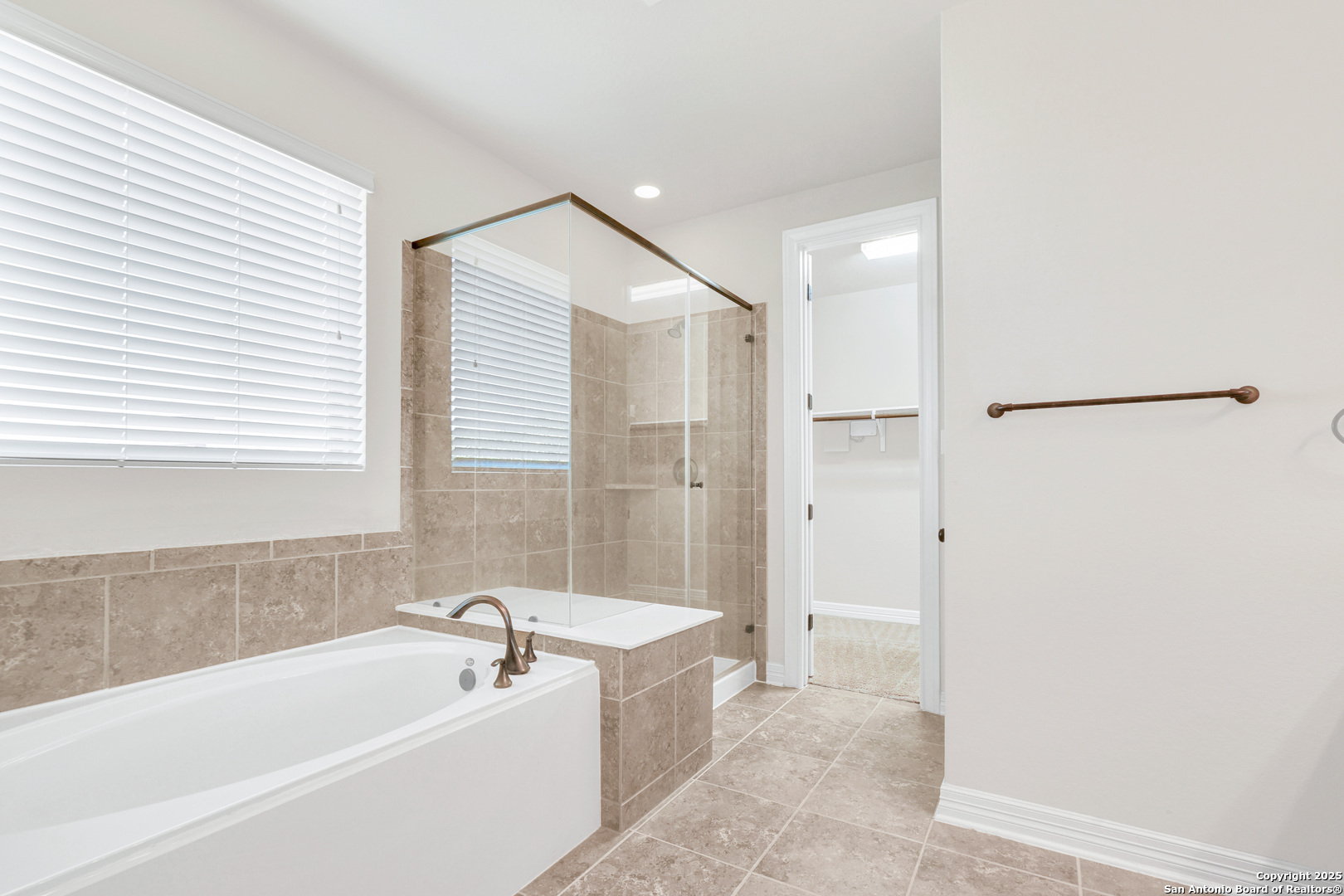11923 Hollering Pass Schertz, TX 78154 - Photo 25 of 43 a bathroom with a bathtub and a shower