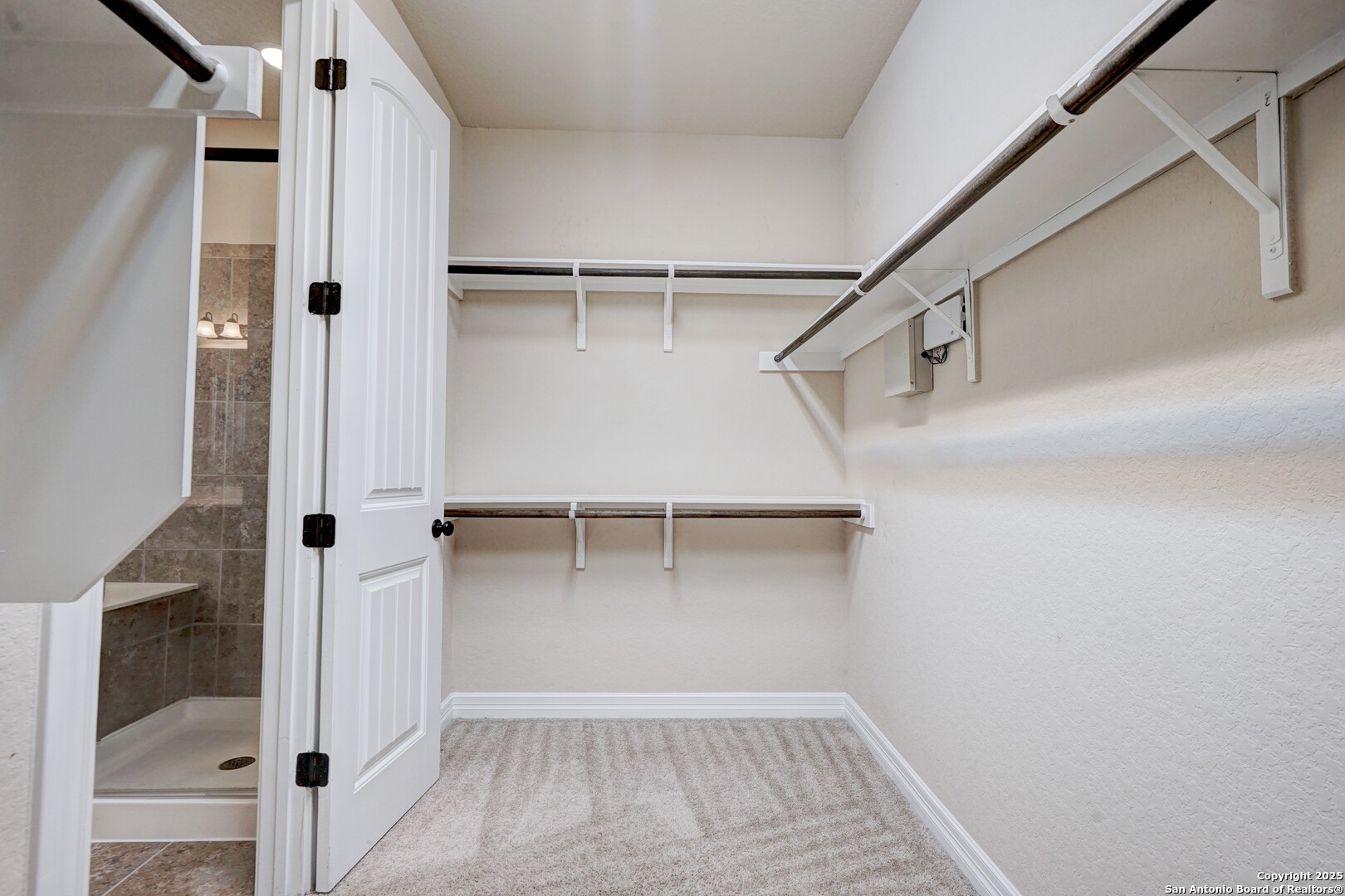 11923 Hollering Pass Schertz, TX 78154 - Photo 28 of 43 a view of walk in closet with empty racks