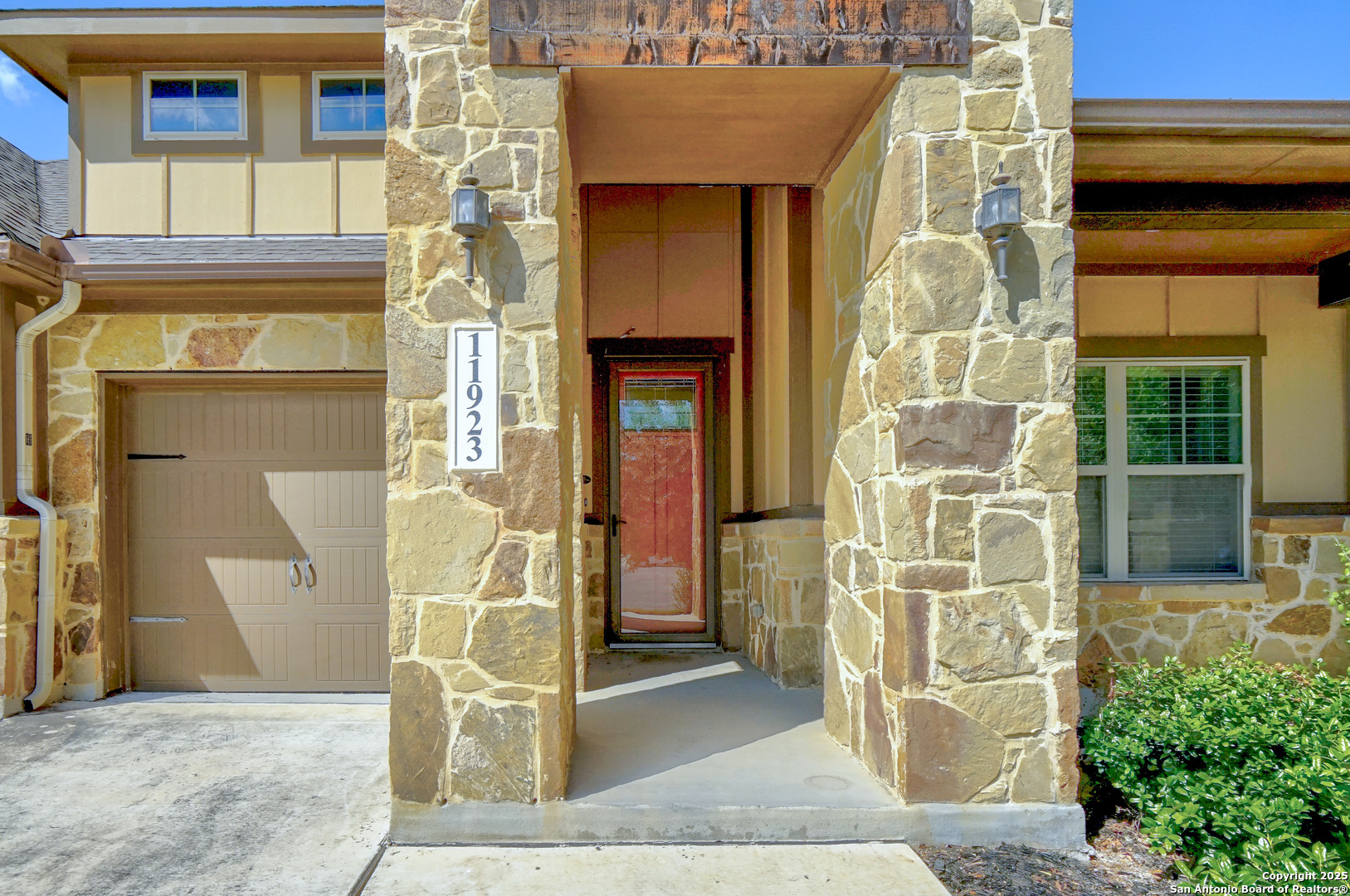 11923 Hollering Pass Schertz, TX 78154 - Photo 4 of 43 a view of entrance gate of a brick building