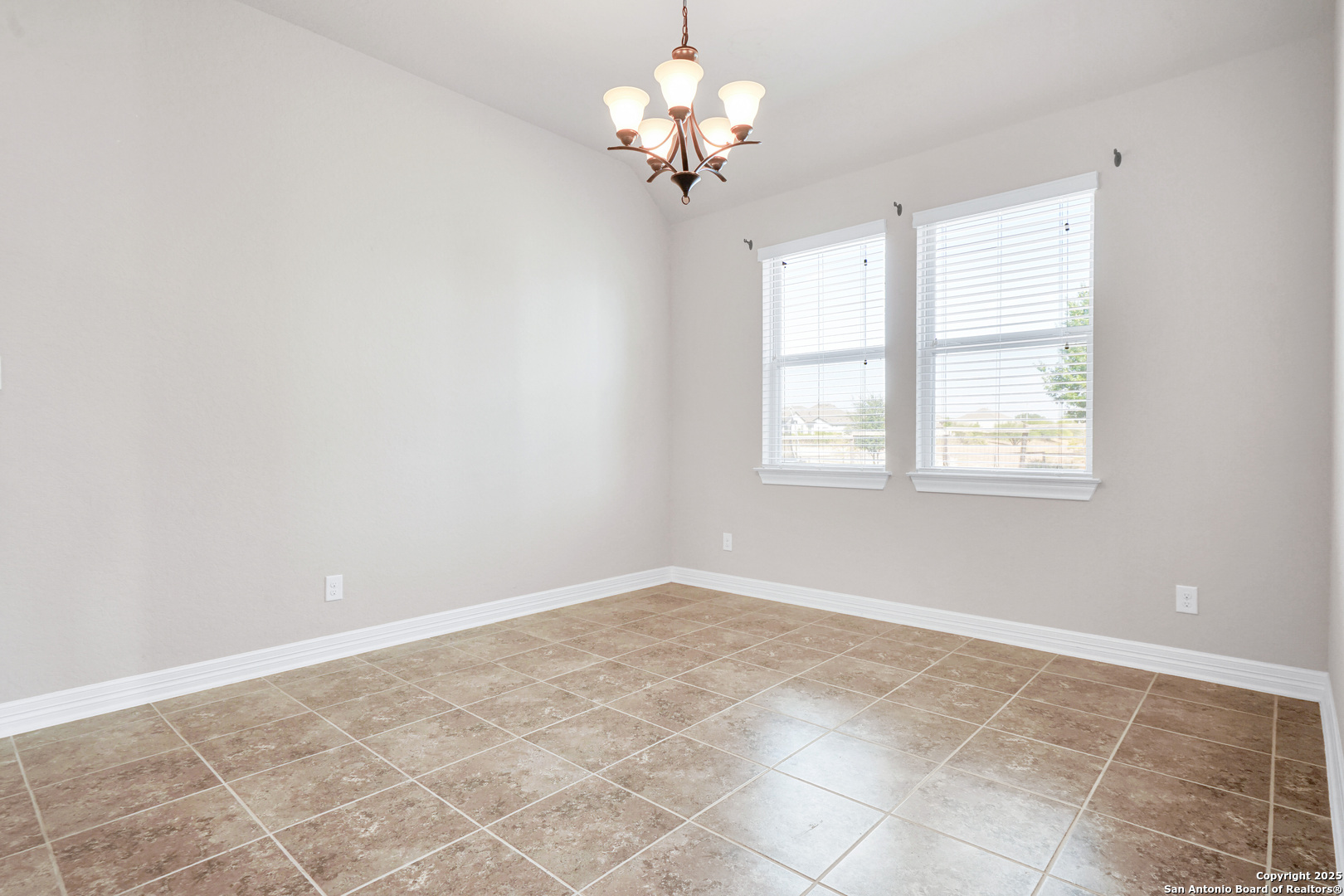11923 Hollering Pass Schertz, TX 78154 - Photo 7 of 43 a view of a chandelier fan and window