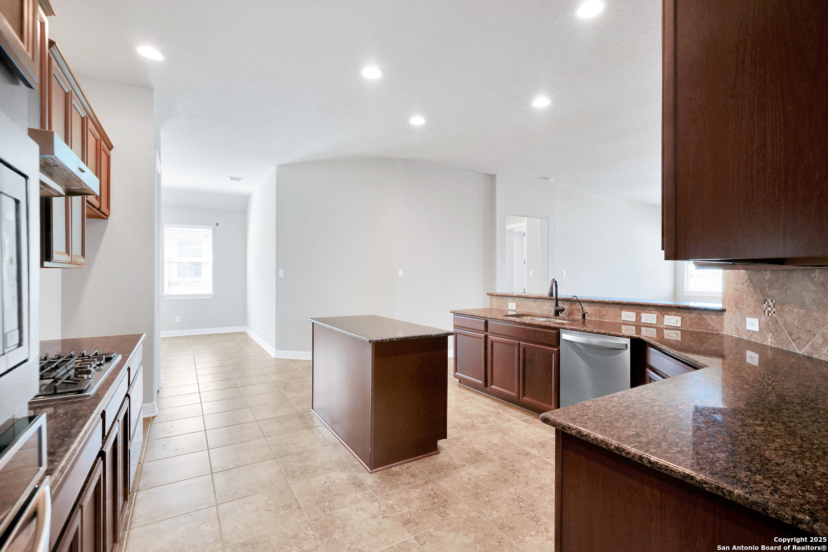 11923 Hollering Pass Schertz, TX 78154 - Photo 9 of 43 a kitchen with stainless steel appliances granite countertop a sink stove and refrigerator