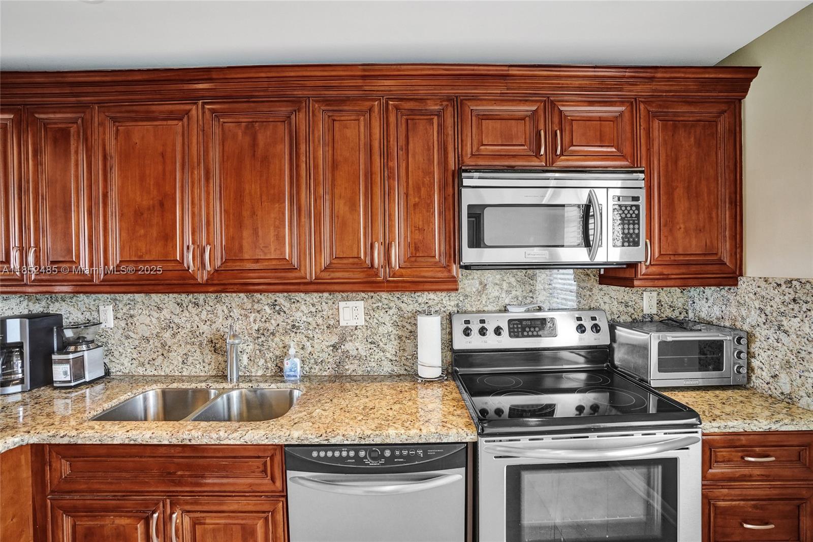 1401 North Riverside Drive, Unit 1005 Pompano Beach, FL 33062 - Photo 13 of 49 a kitchen with stainless steel appliances granite countertop a stove and a microwave