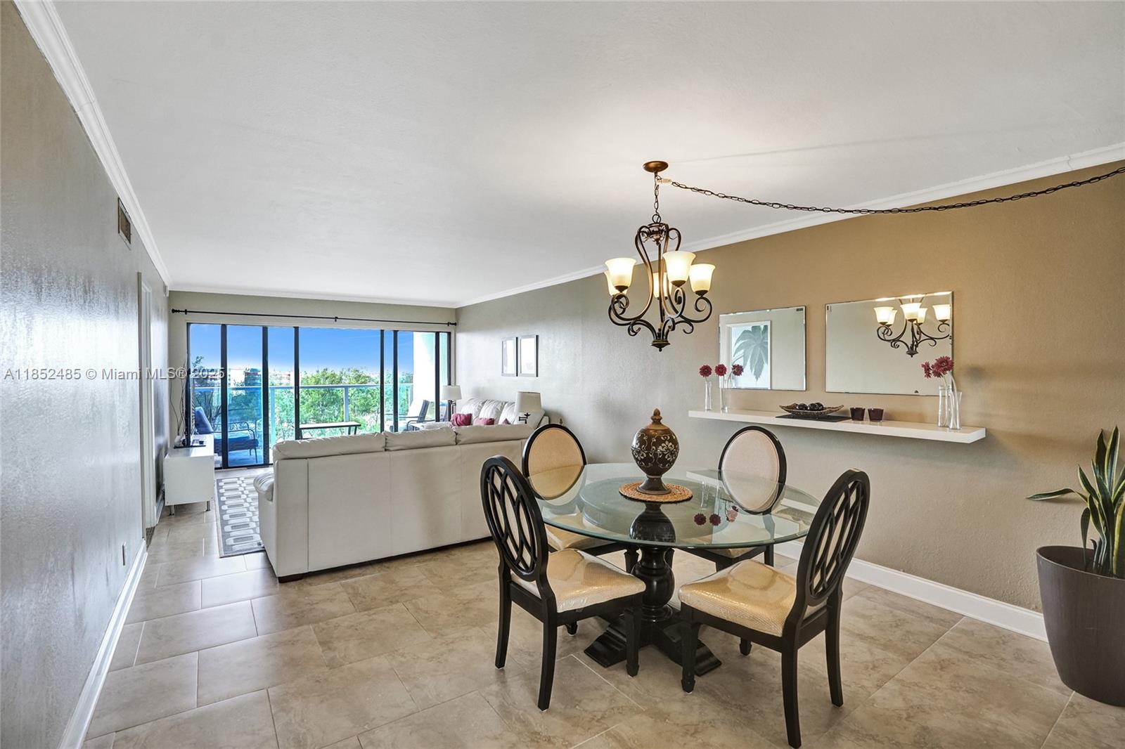 1401 North Riverside Drive, Unit 1005 Pompano Beach, FL 33062 - Photo 20 of 49 a view of a dining room with furniture wooden floor and chandelier