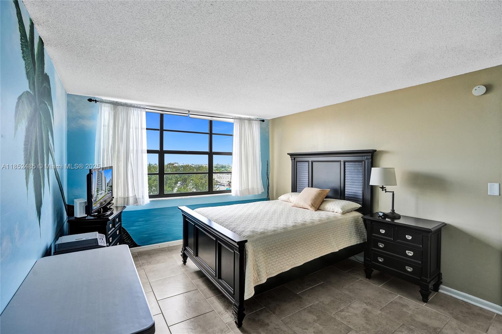 1401 North Riverside Drive, Unit 1005 Pompano Beach, FL 33062 - Photo 2 of 49 a bed sitting in a spacious bedroom next to a window