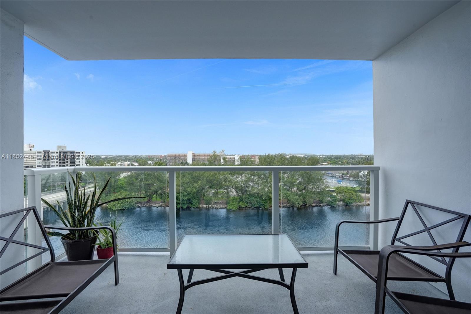 1401 North Riverside Drive, Unit 1005 Pompano Beach, FL 33062 - Photo 35 of 49 a balcony with table and chairs